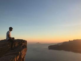 person sitting on mountain top