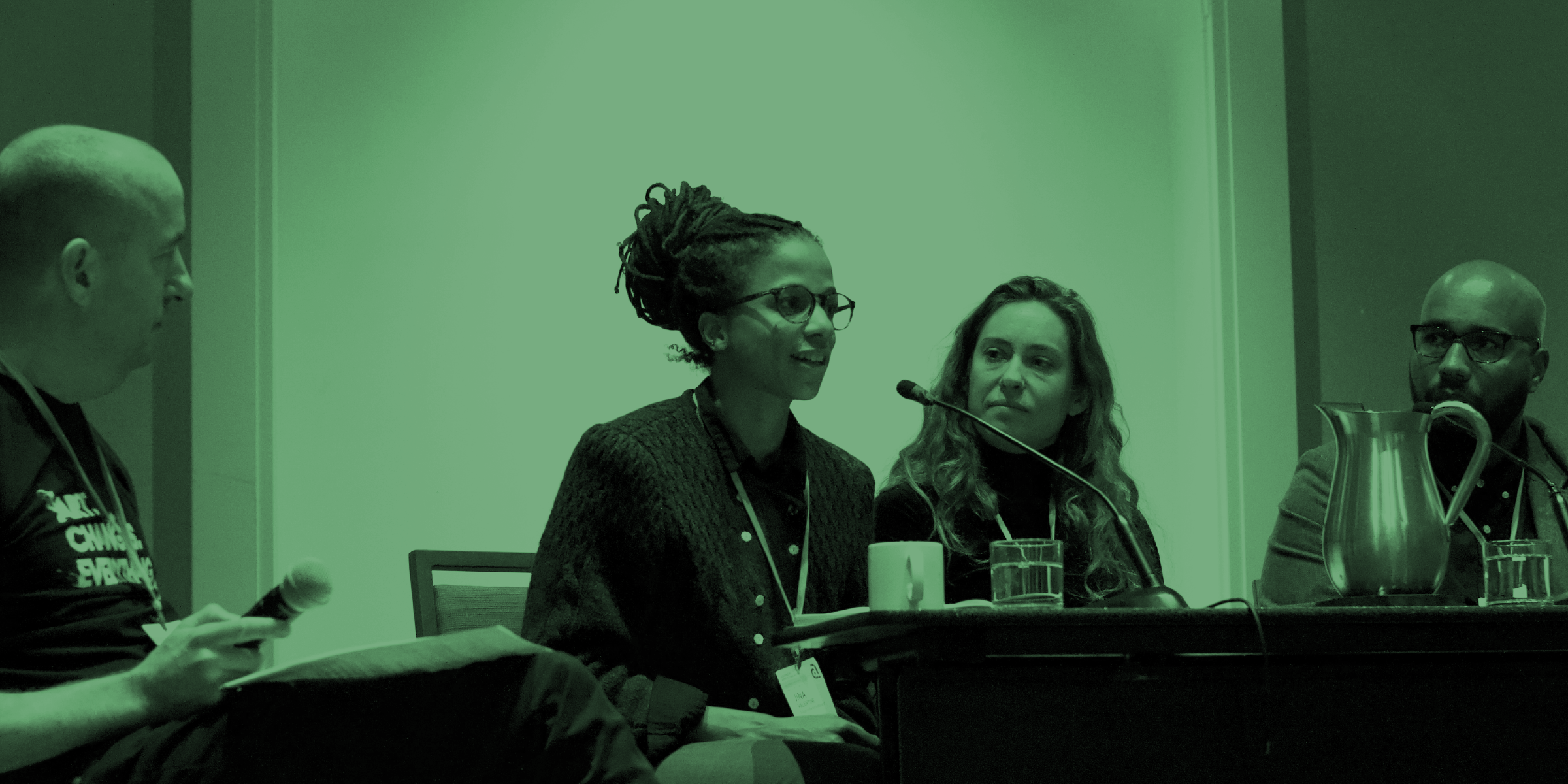 Photo of a person speaking into a microphone