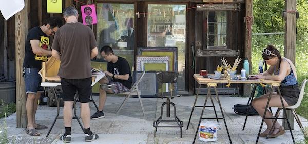 Photo of artists at work outdoors